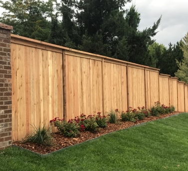 wood-wall-privacy-fence-surrounded-by-plants-grass-and-trees-in-denver-co